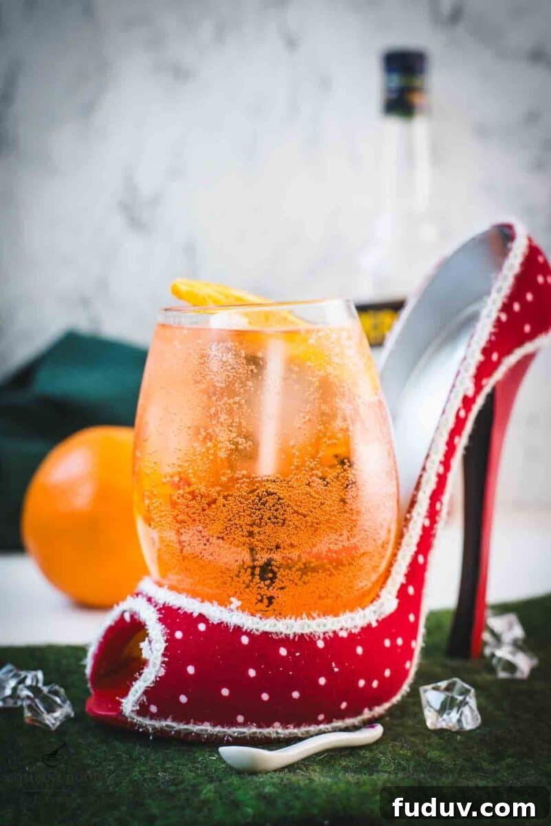 Aperol Spritz Made with Wine: How to Swap Prosecco for Table Wine 6 Aperol spritz with white wine instead of prosecco playfully served in a red and white polka dot high heel. Garnished with n orange slice.
