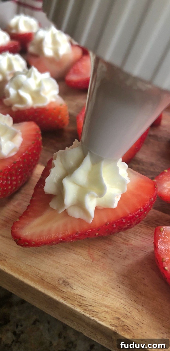Piping filling into strawberries