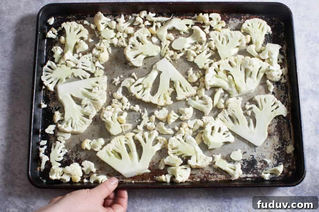 Sliced cauliflower on a sheet pan.