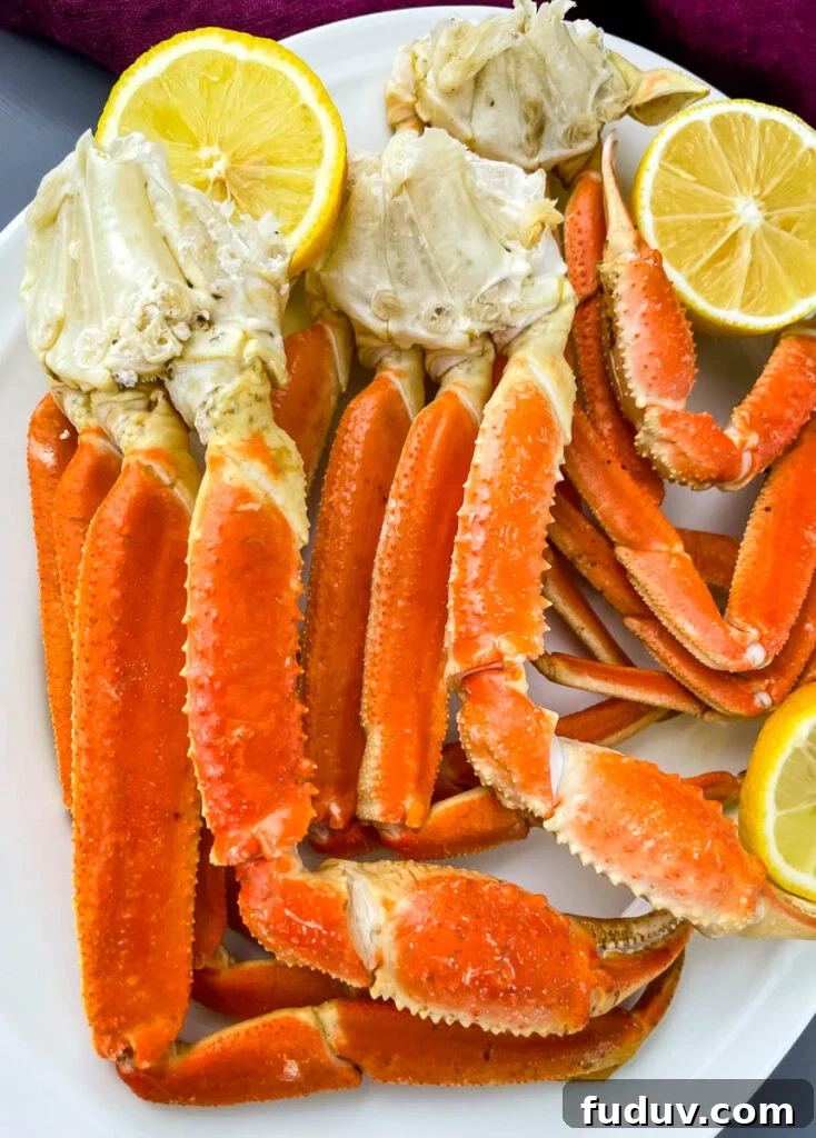 Instant Pot crab legs on a white plate with lemon