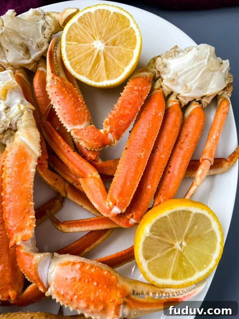 Instant Pot crab legs on a white plate with lemon