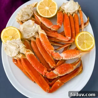 Instant Pot crab legs on a white plate with lemon