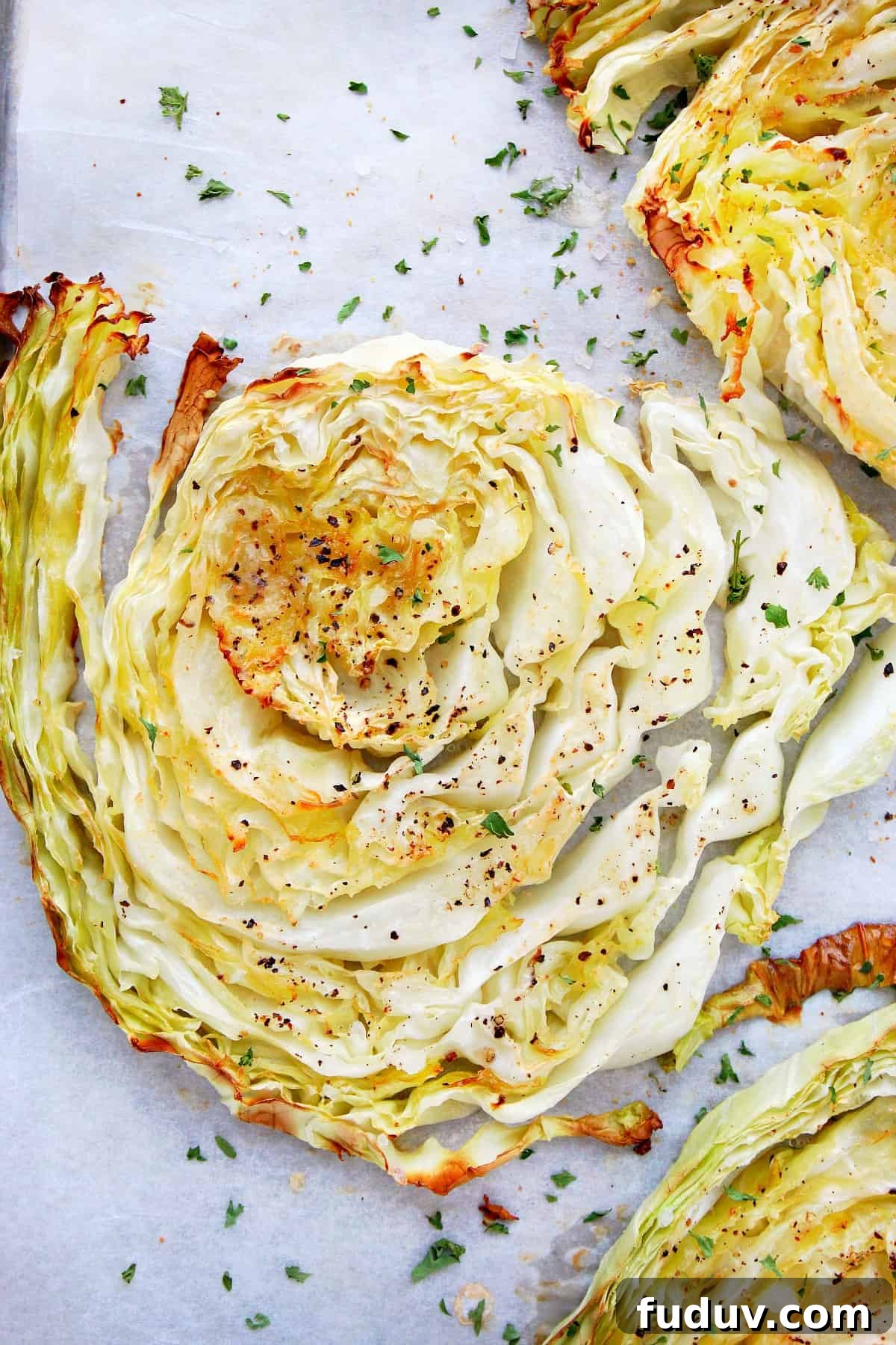 Simple Roasted Cabbage Recipe Roasted cabbage slice on parchment.