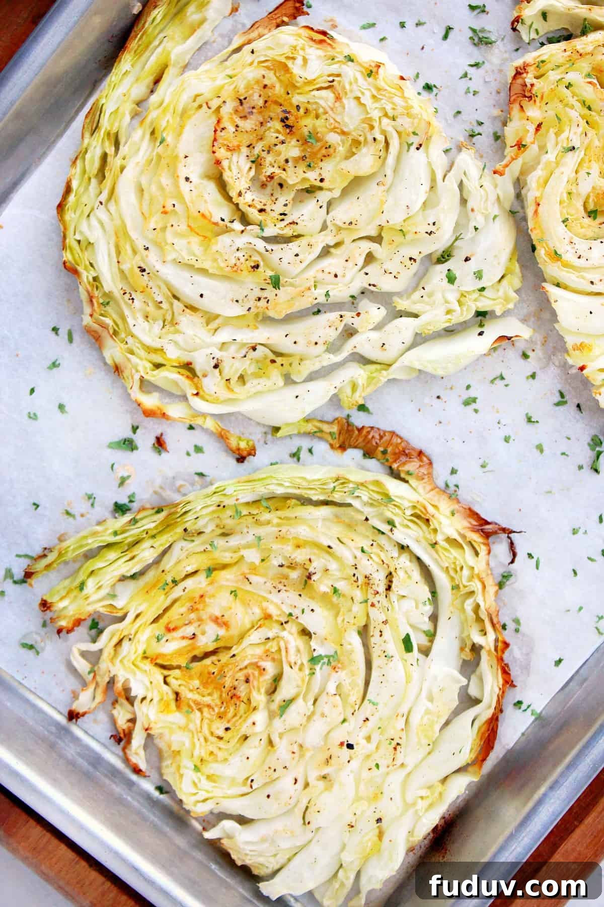 Easy Roasted Cabbage Sliced, roasted cabbage on a baking sheet.