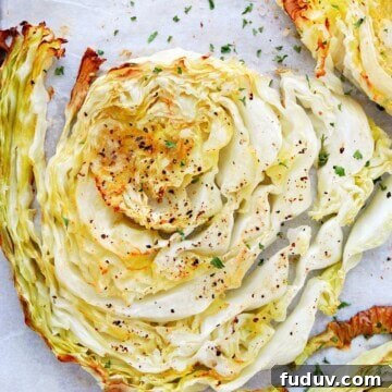 Crispy Roasted Cabbage Wedges with Garlic and Parmesan 3 Roasted cabbage slice on parchment.