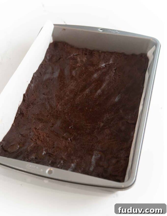 Thin Mint Cookie Bars Recipe with Chocolate Ganache 6 raw chocolate cookie dough pressed into 9x13 metal pan