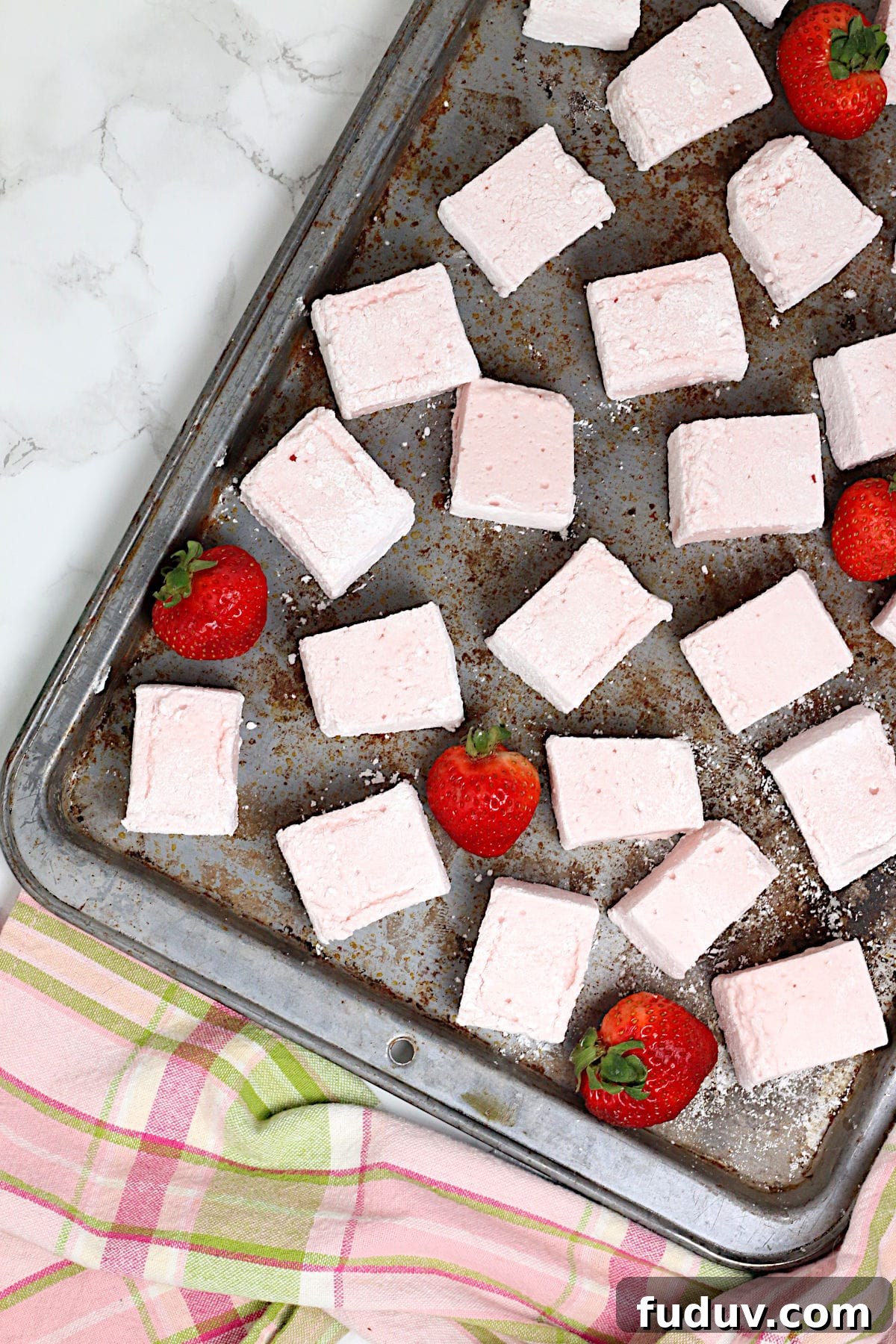 An overhead photo of Homemade Strawberry Marshmallows on a baking sheet.