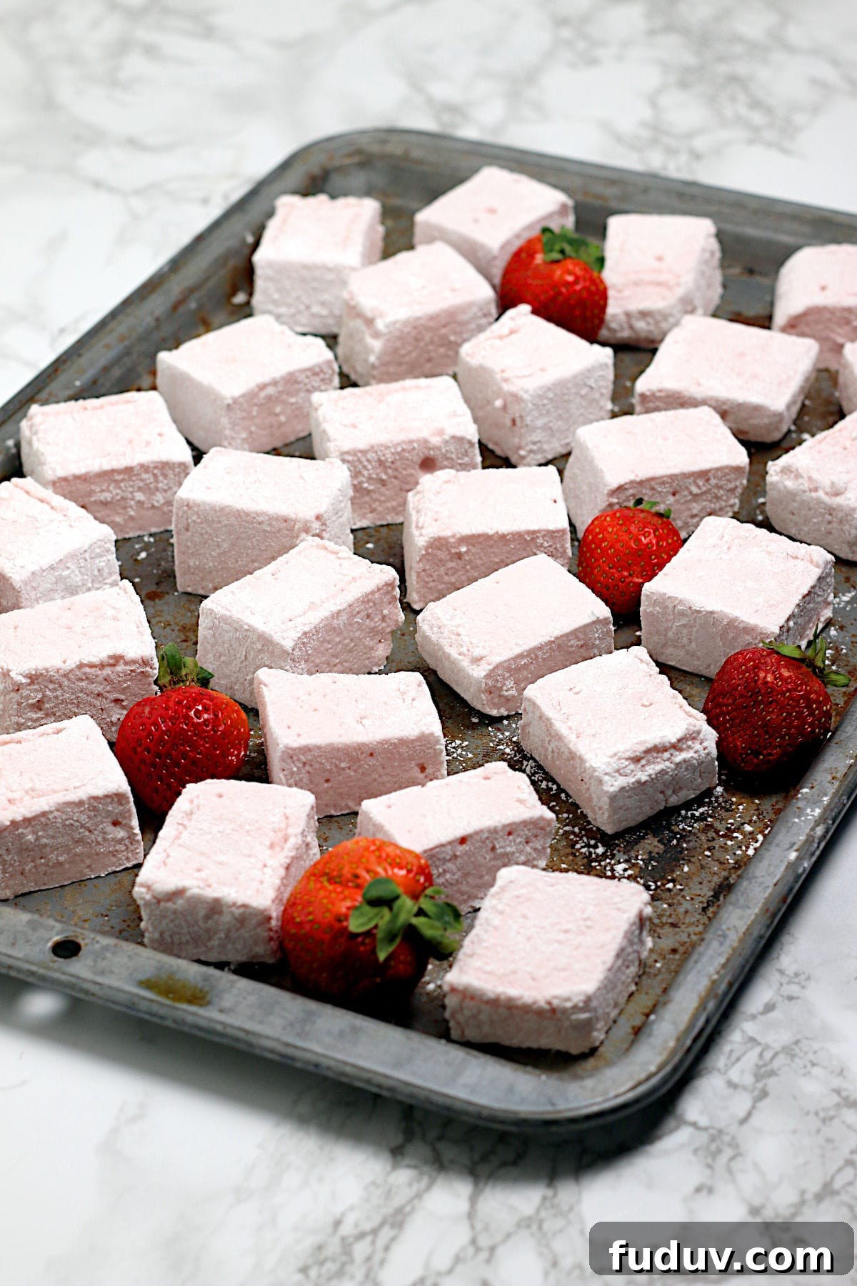 Homemade Strawberry Marshmallows on a baking sheet.