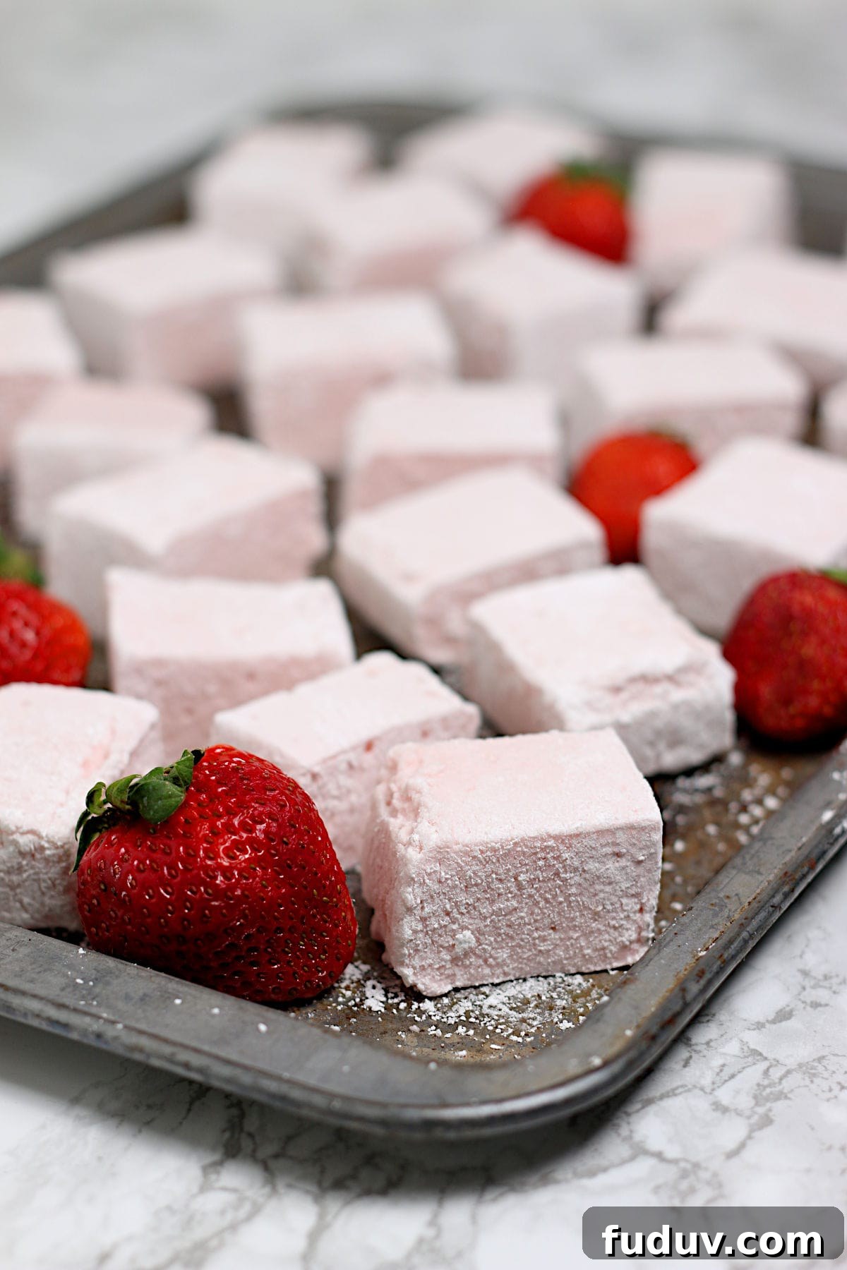 Homemade Strawberry Marshmallows on a baking sheet.