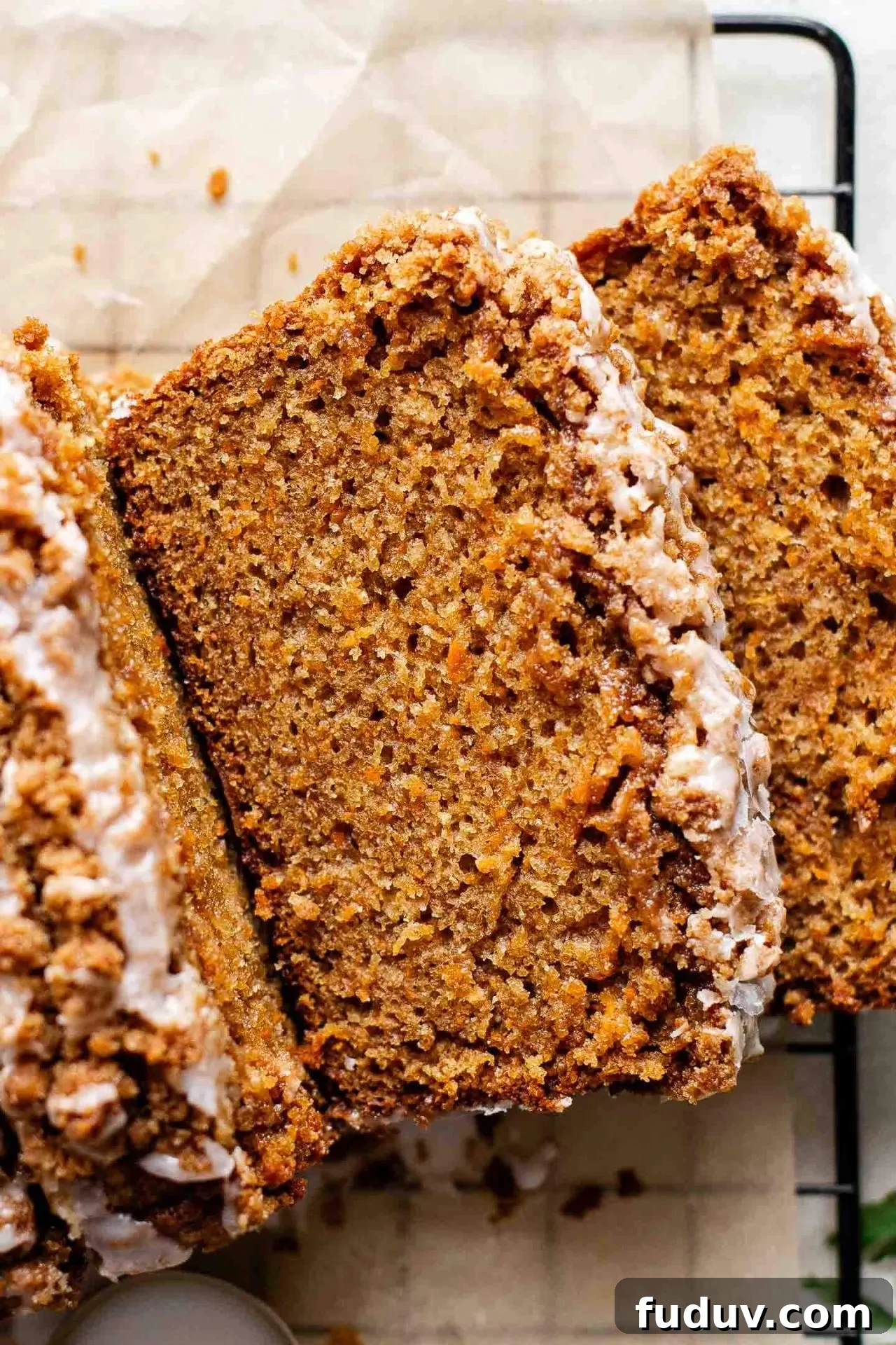 sliced carrot bread on parchment lined wire rack