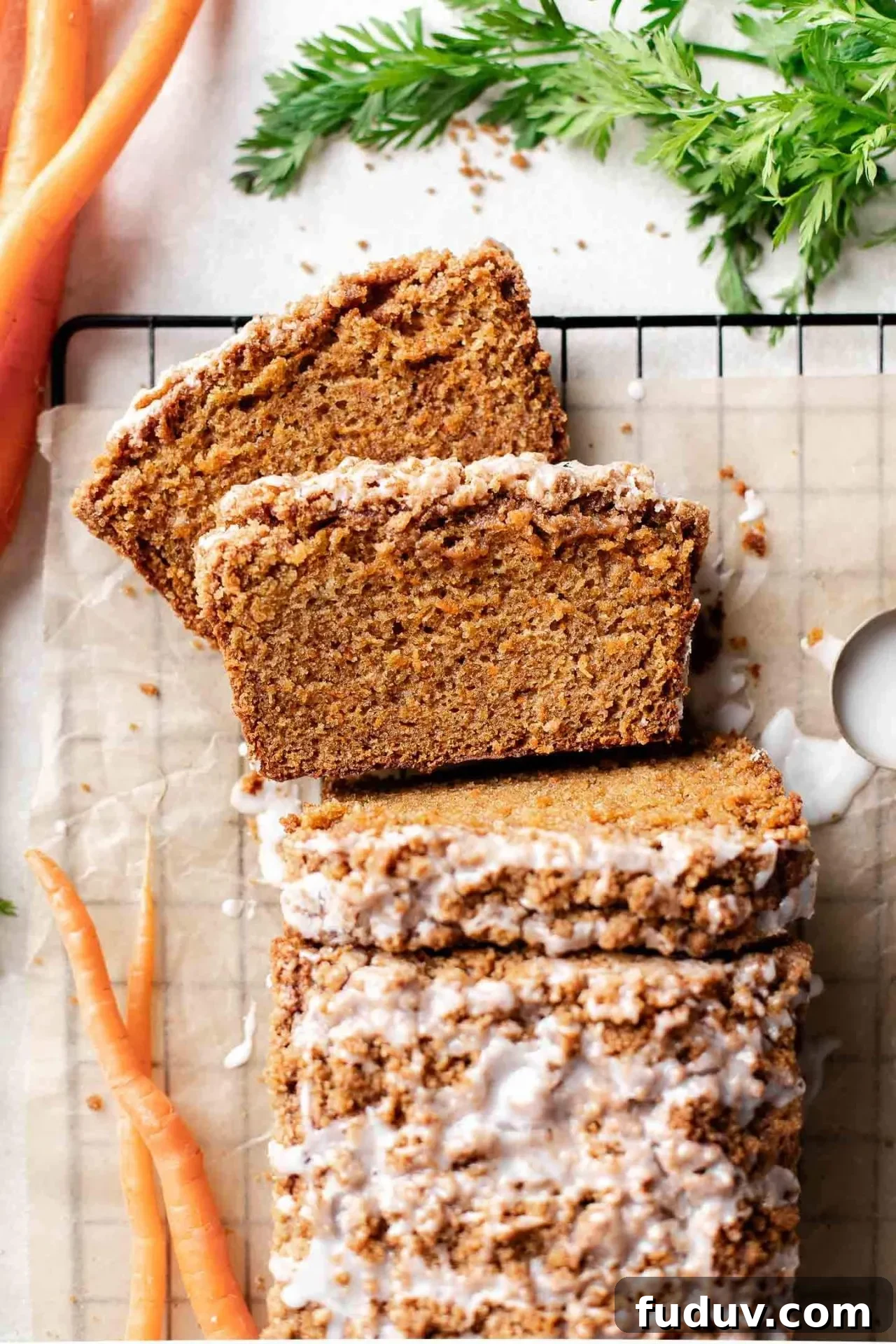 sliced carrot bread on parchment lined wire rack