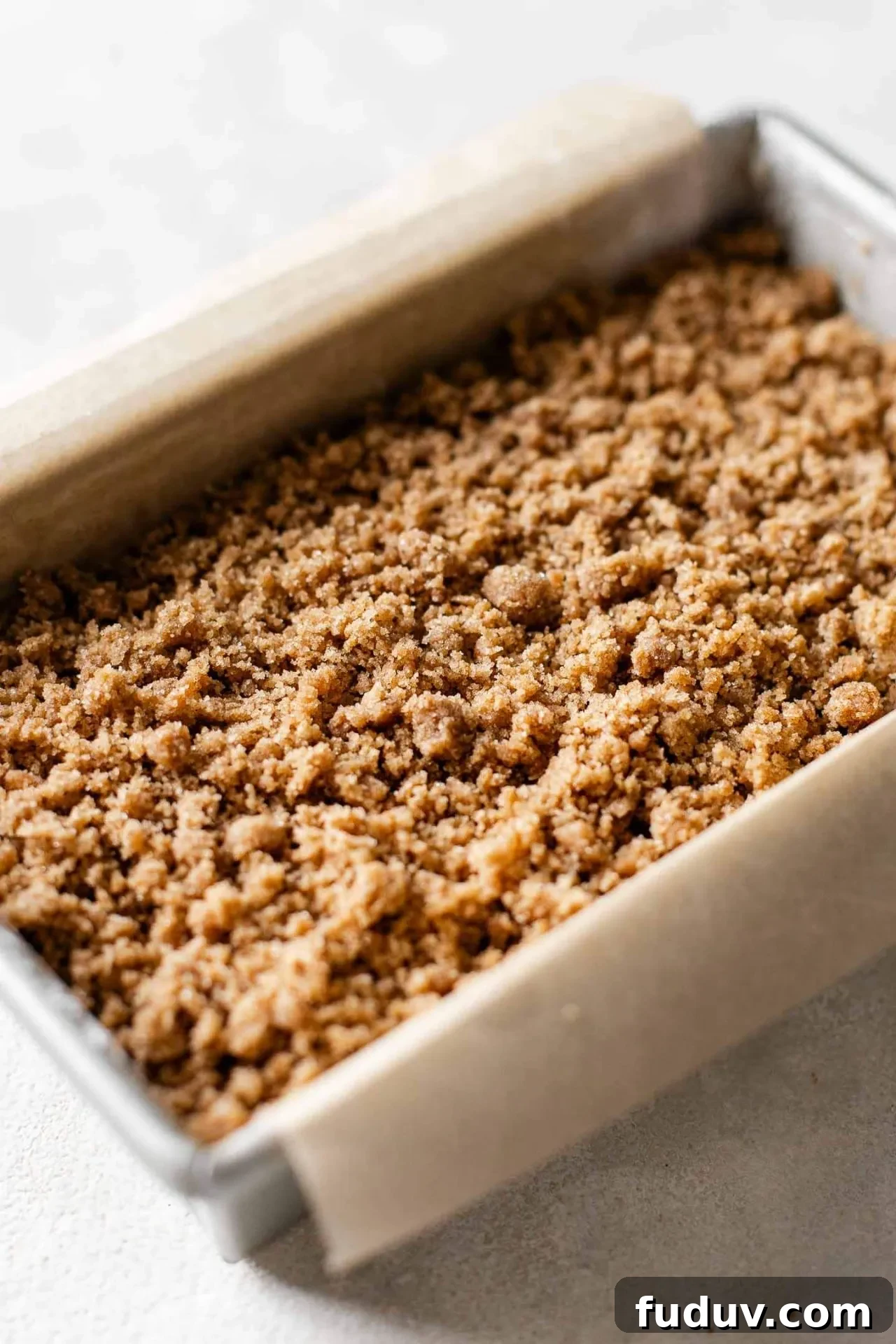 MOIST carrot bread batter layered with streusel on top in pan