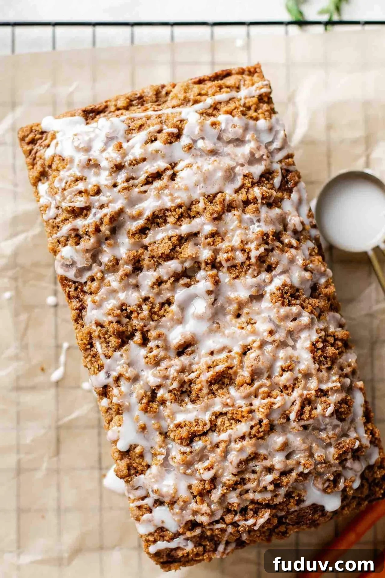 iced MOIST carrot bread on parchment lined wire rack