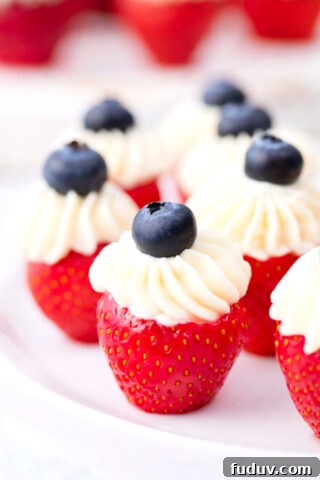 Patriotic stuffed strawberries topped with blueberries.