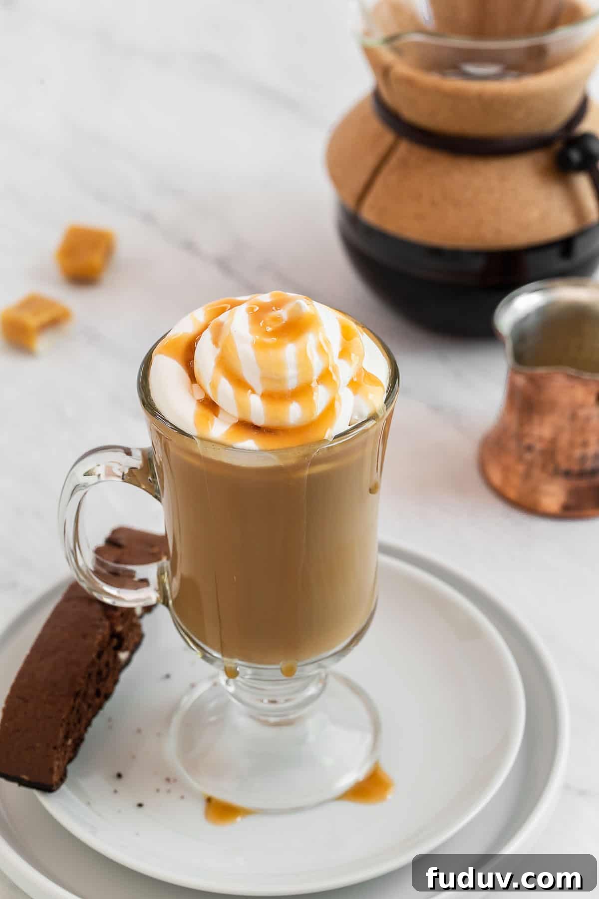 How to Make a Rich Caramel Latte at Home in Minutes 6 Caramel latte garnished with whipped cream and caramel drizzle.