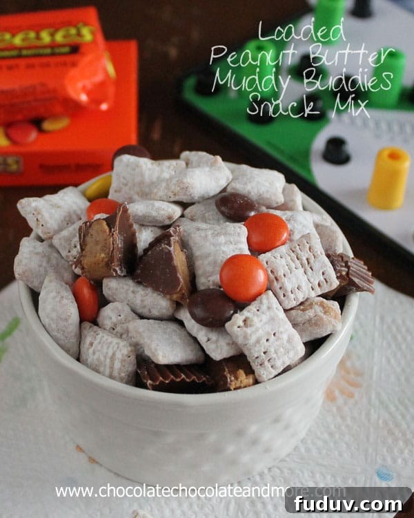 Loaded Peanut Butter Muddy Buddies Snack Mix-with Reeses Pieces and Reeses Peanut Butter Cups your family will eat it up!