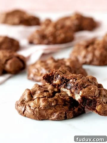 White and pink surface with chocolate walnut cookies, whole and half