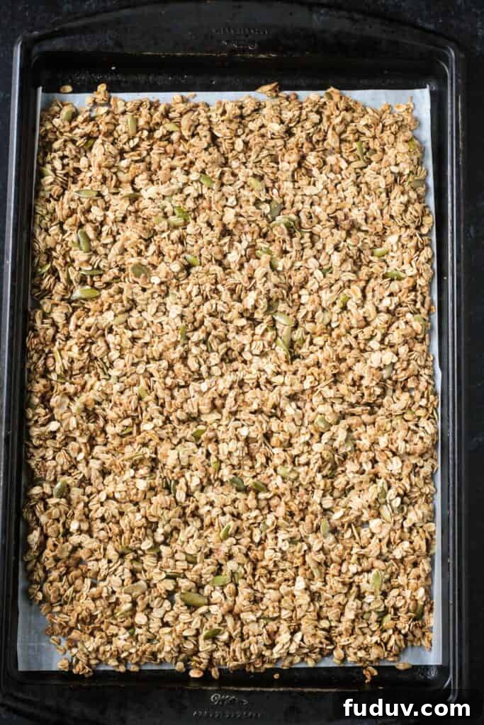 Vegan Pumpkin Spice Granola Recipe for Fall Breakfasts 8 Baked granola on a rimmed baking sheet.