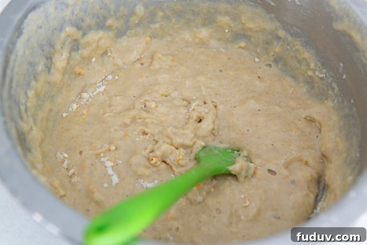 The stirred batter in a stainless steel bowl