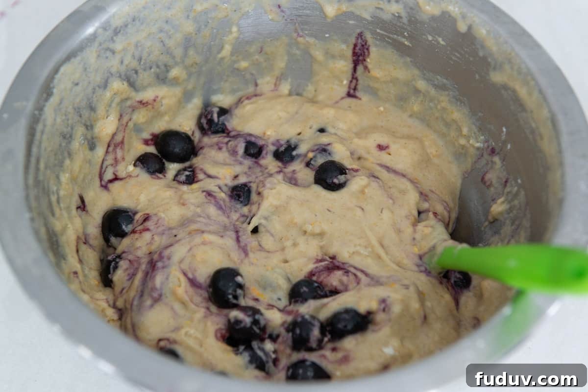 Frozen blueberries stirred into the muffin batter