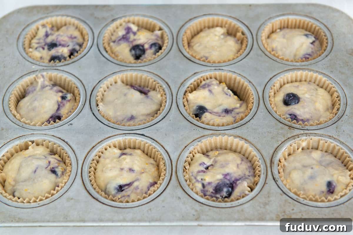 Individual cups in the tray filled with batter