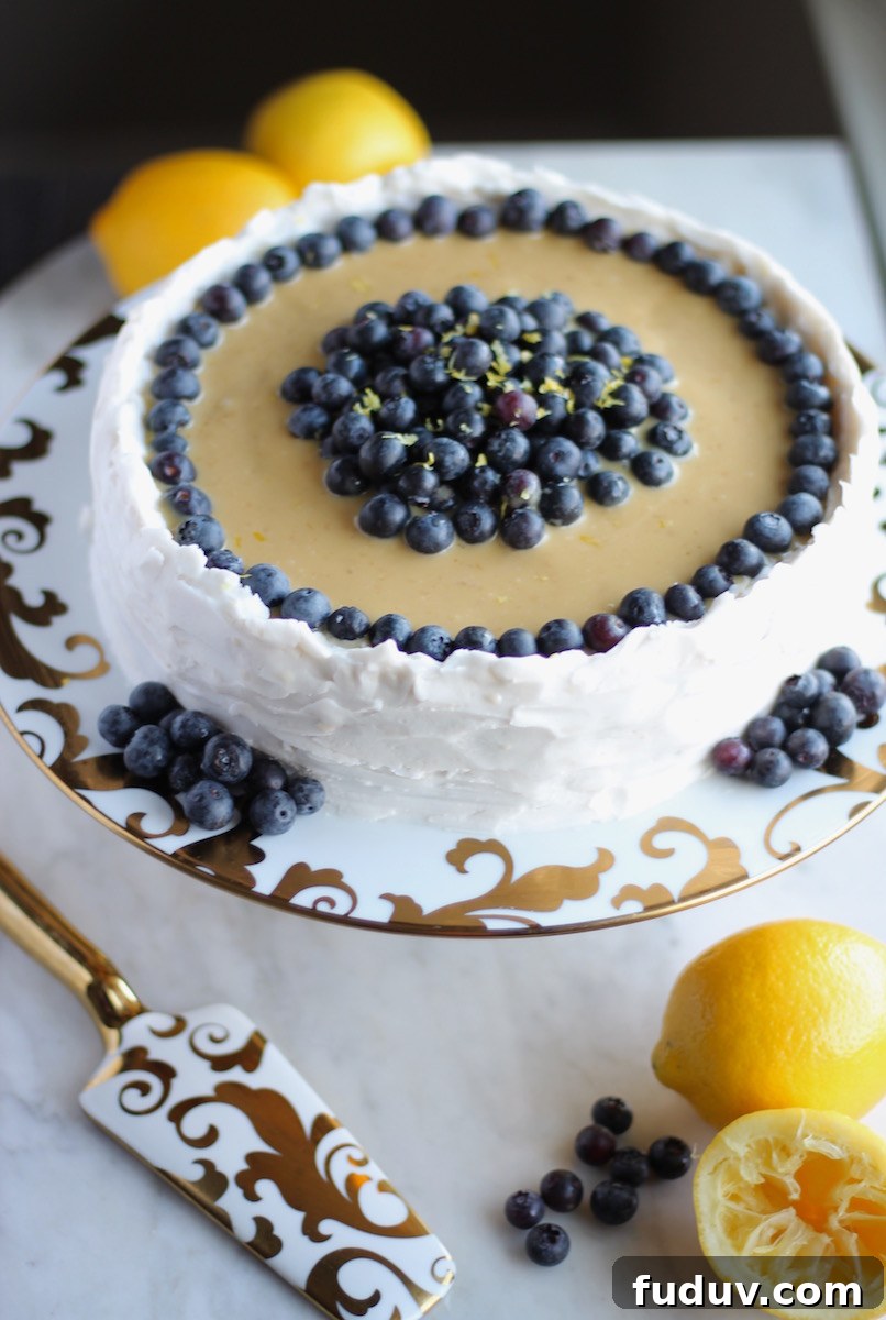 Paleo Lemon Blueberry Layer Cake (AIP) - a luscious lemon cake is filled with blueberry compote and topped with lemon cream and whipped coconut frosting! | fedandfulfilled.com