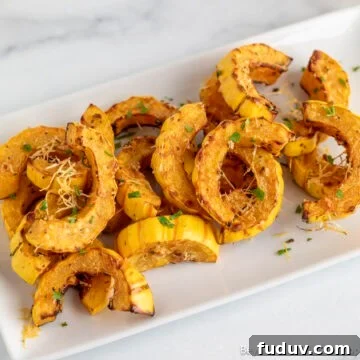Roasted Delicata Squash on a white platter.