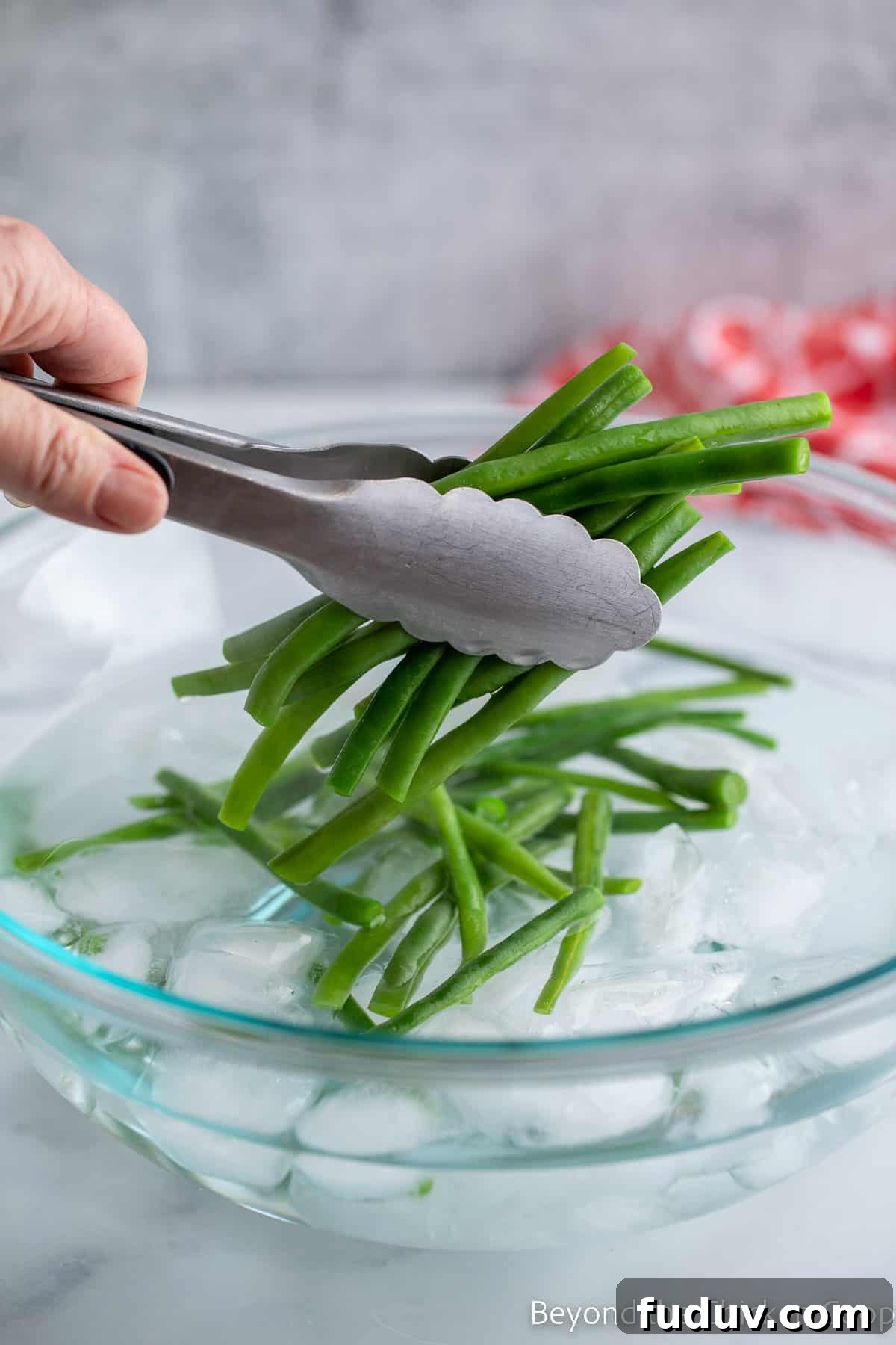 Putting beans into ice water. 