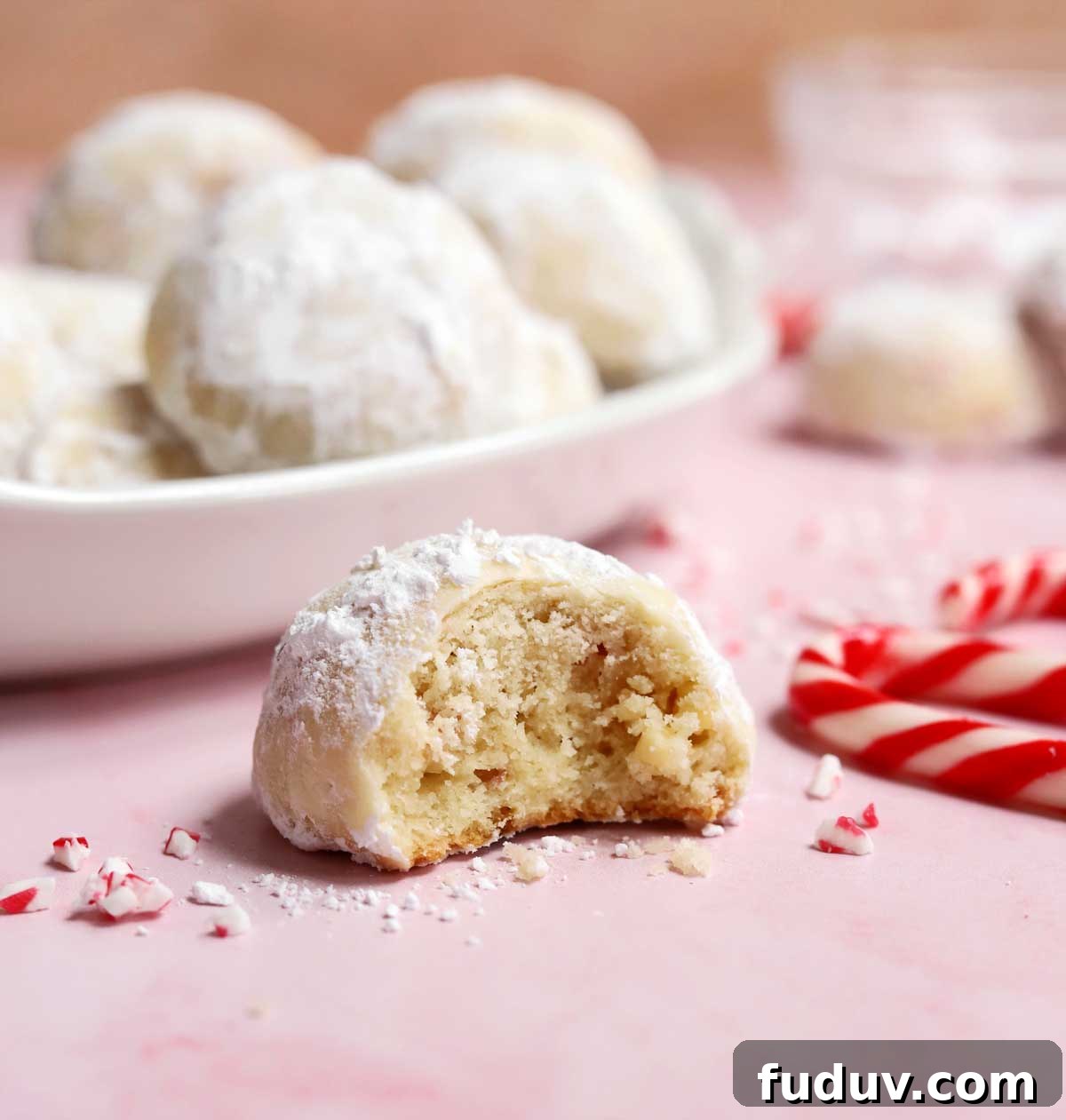 peppermint snowball cookies with bite showing tender insides