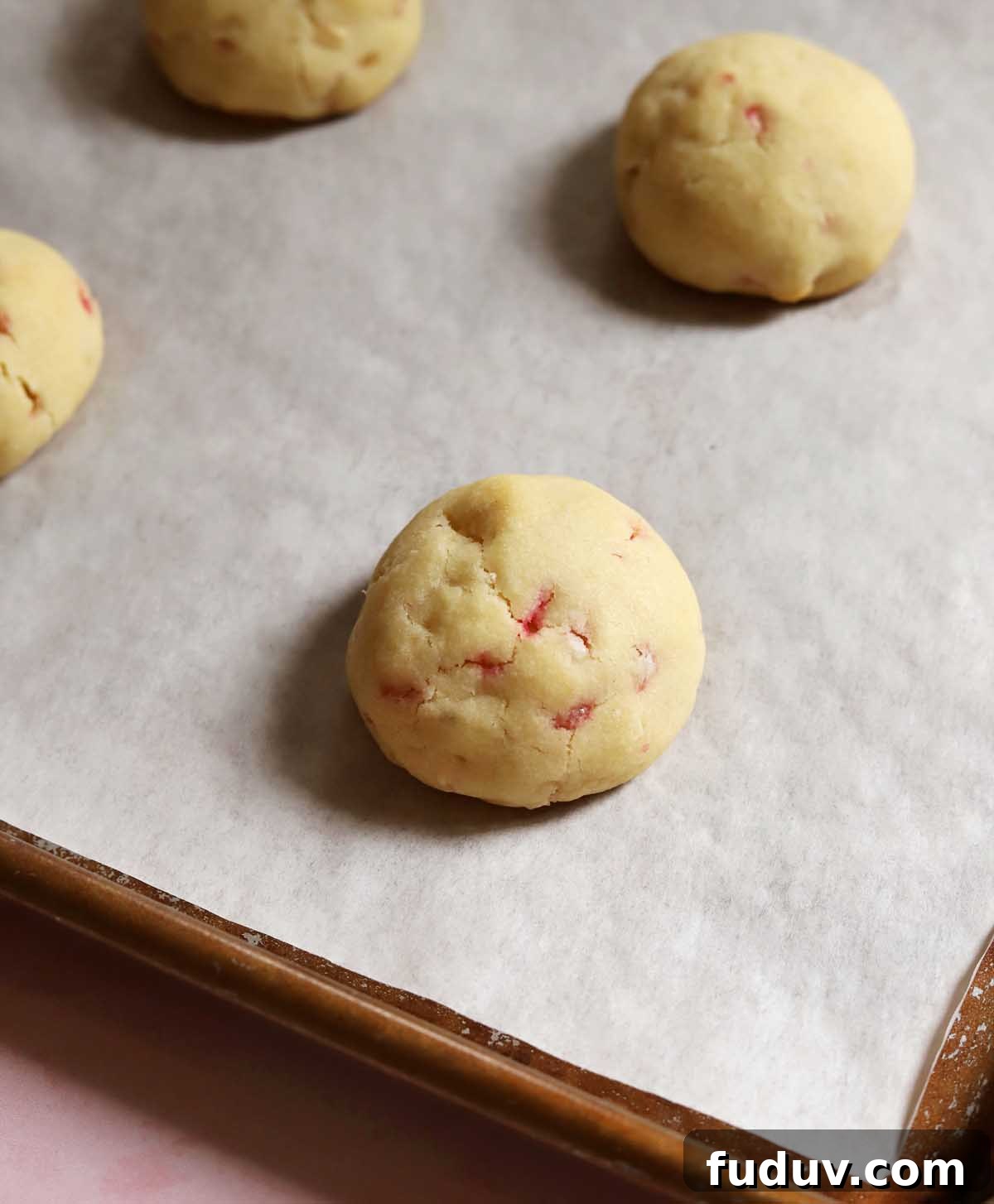 peppermint snowball cookies on cookie sheet after baking