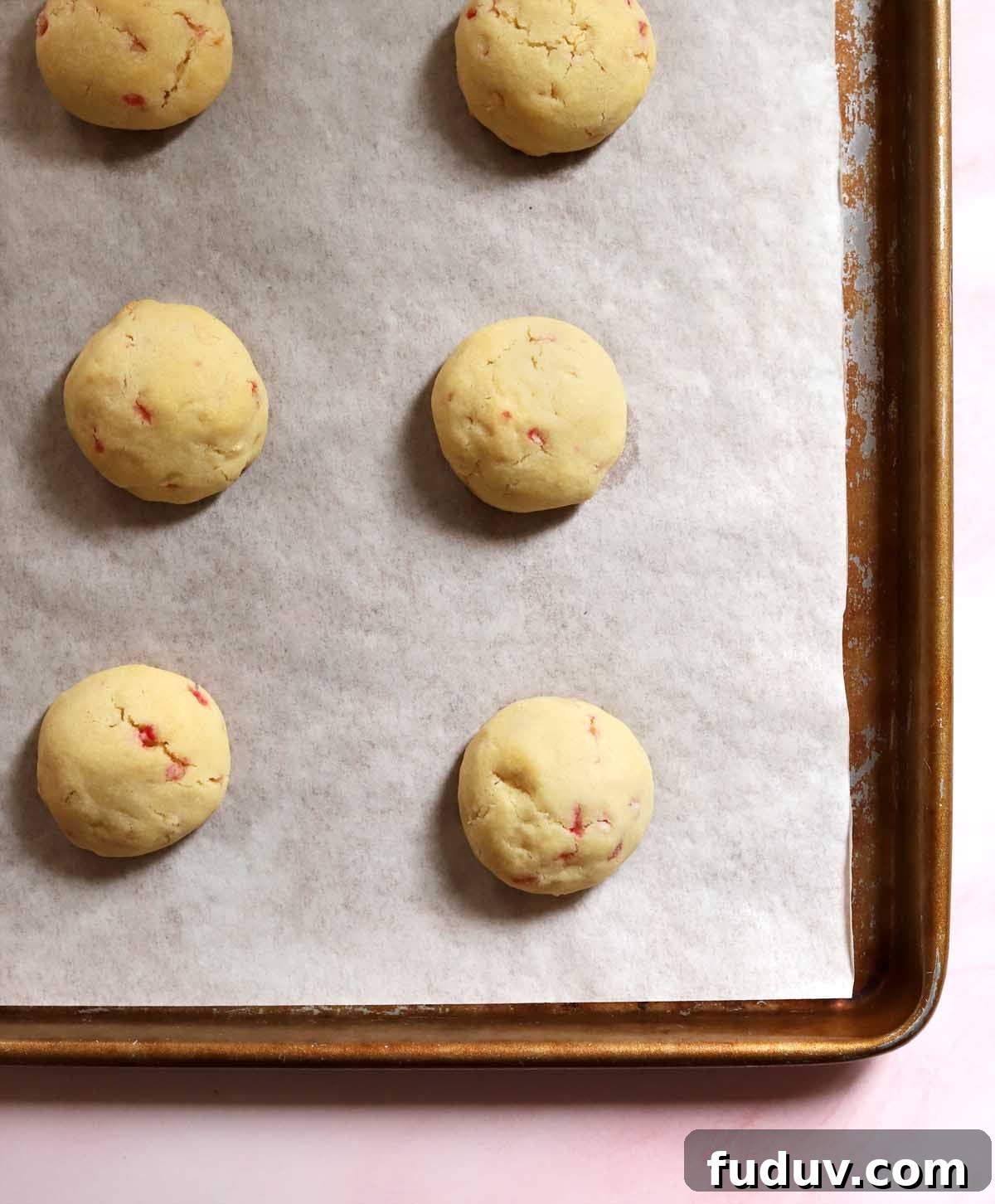 top view of peppermint snowball cookies on cookie sheet after baking