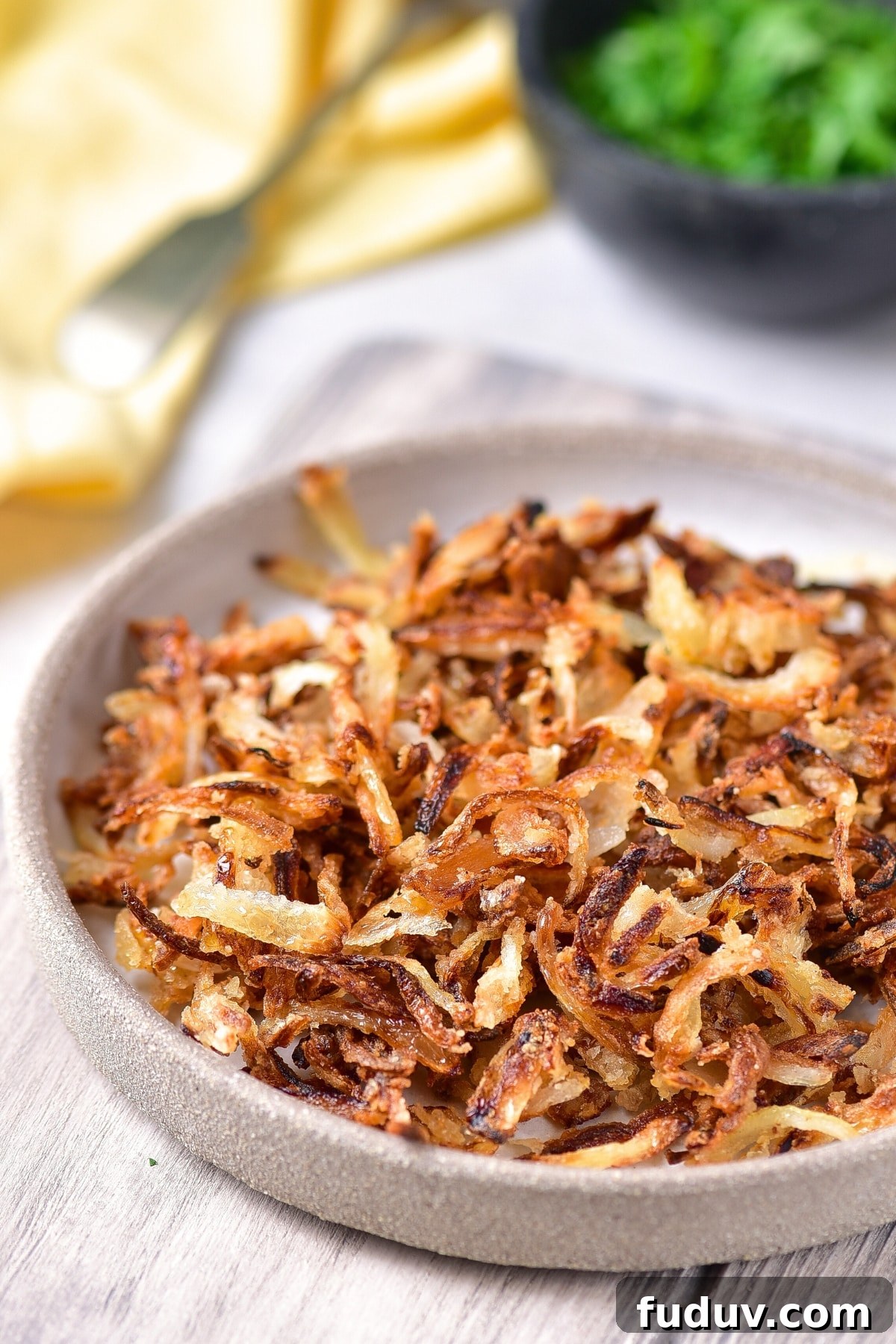 A plate of crispy gluten-free fried onions.