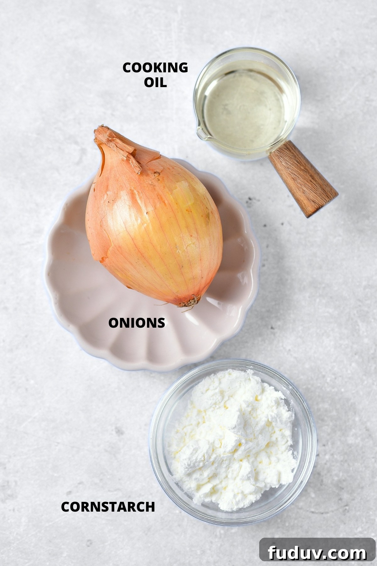 Ingredients for gluten-free fried onions recipe laid out on board.