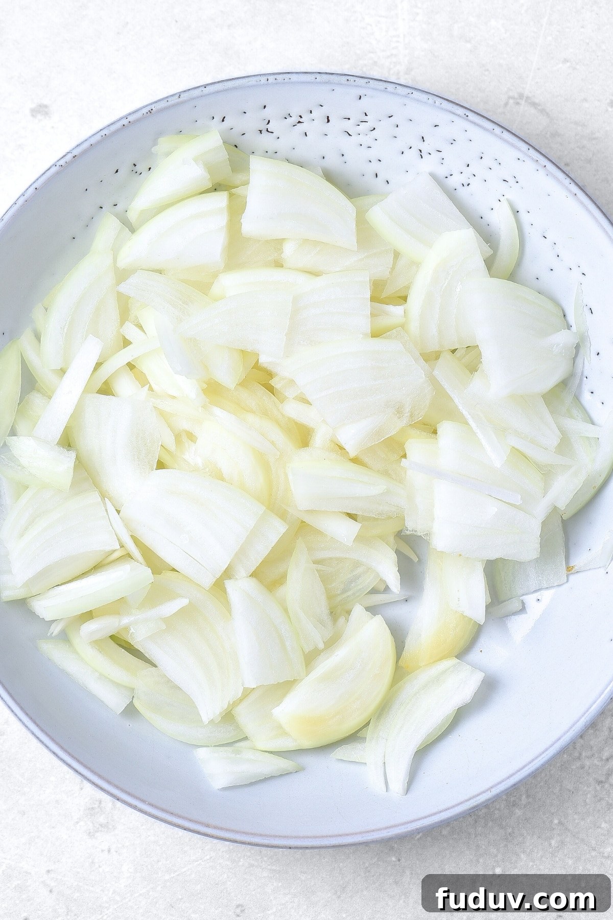 Sliced onions in a bowl.