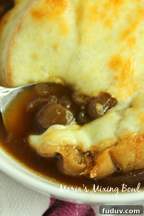 Slow Cooker French Onion Soup Spoon in soup in a white bowl