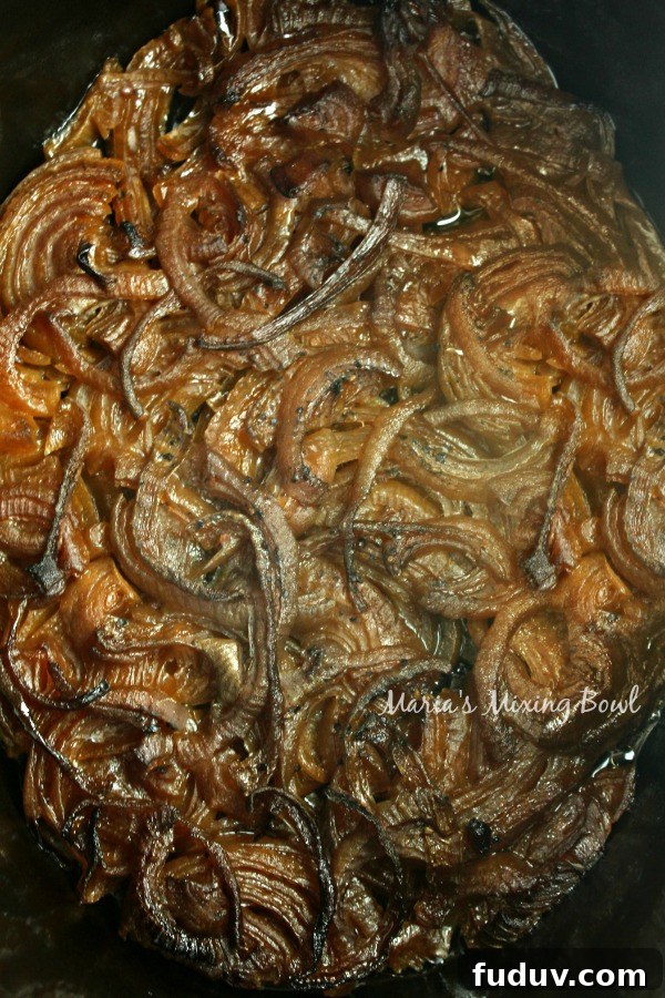Slow Cooker French Onion Soup Recipe for Rich, Melted Gruyère 2 Caramelized onions cooking in slow cooker