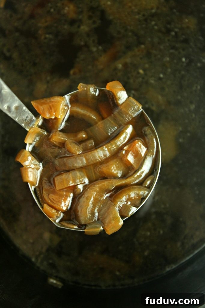 Slow Cooker French Onion Soup Recipe for Rich, Melted Gruyère 3 Ladle full of French onion soup over slow cooker