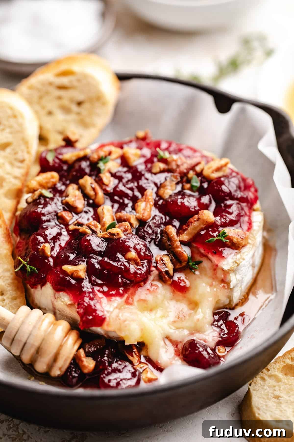 Melted brie cheese topped with cranberry sauce and pecans.