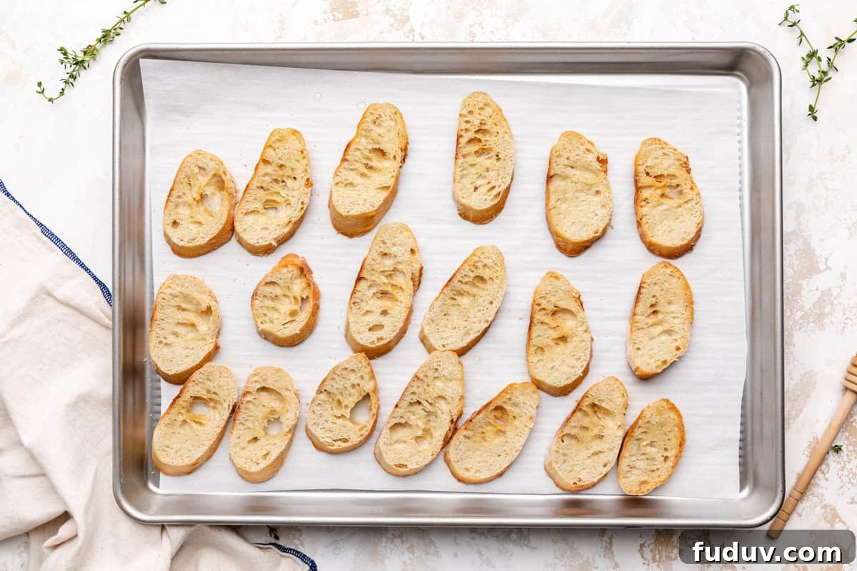 Toasted bread slices on a sheet pan.