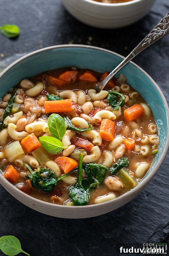 bowl of instant pot minestrone soup with a spoon on the side