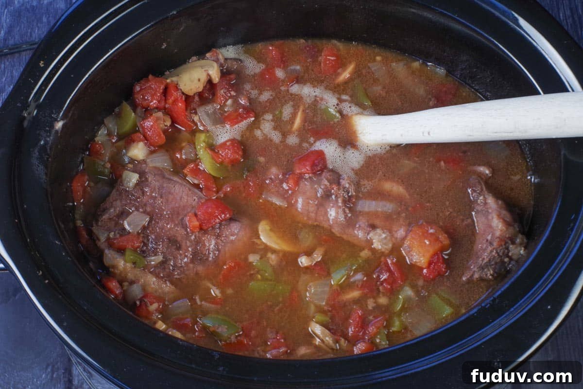 cooked swiss steak in a slow cooker