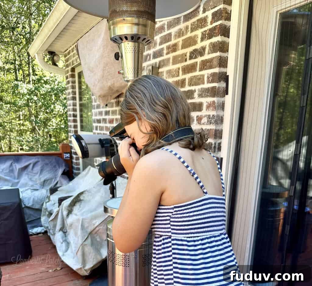 girl taking a picture with a dslr camera.