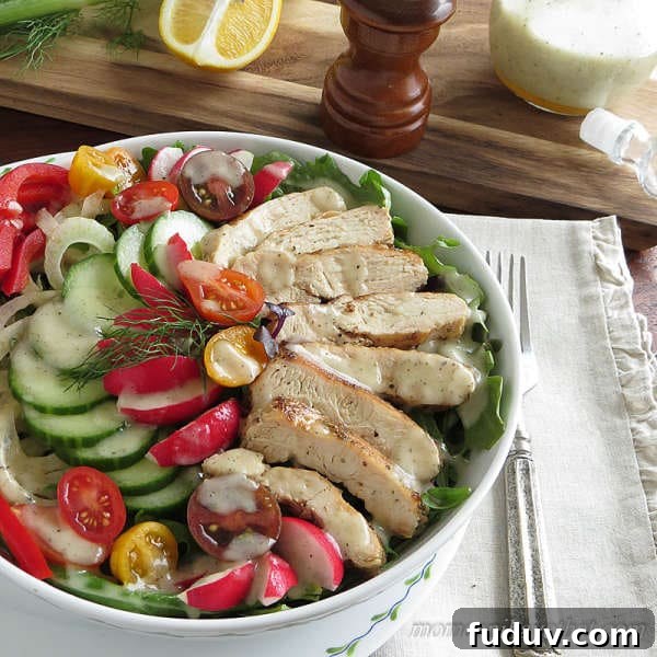 Grilled chicken salad with vegetables and dressing in a bowl with napkin