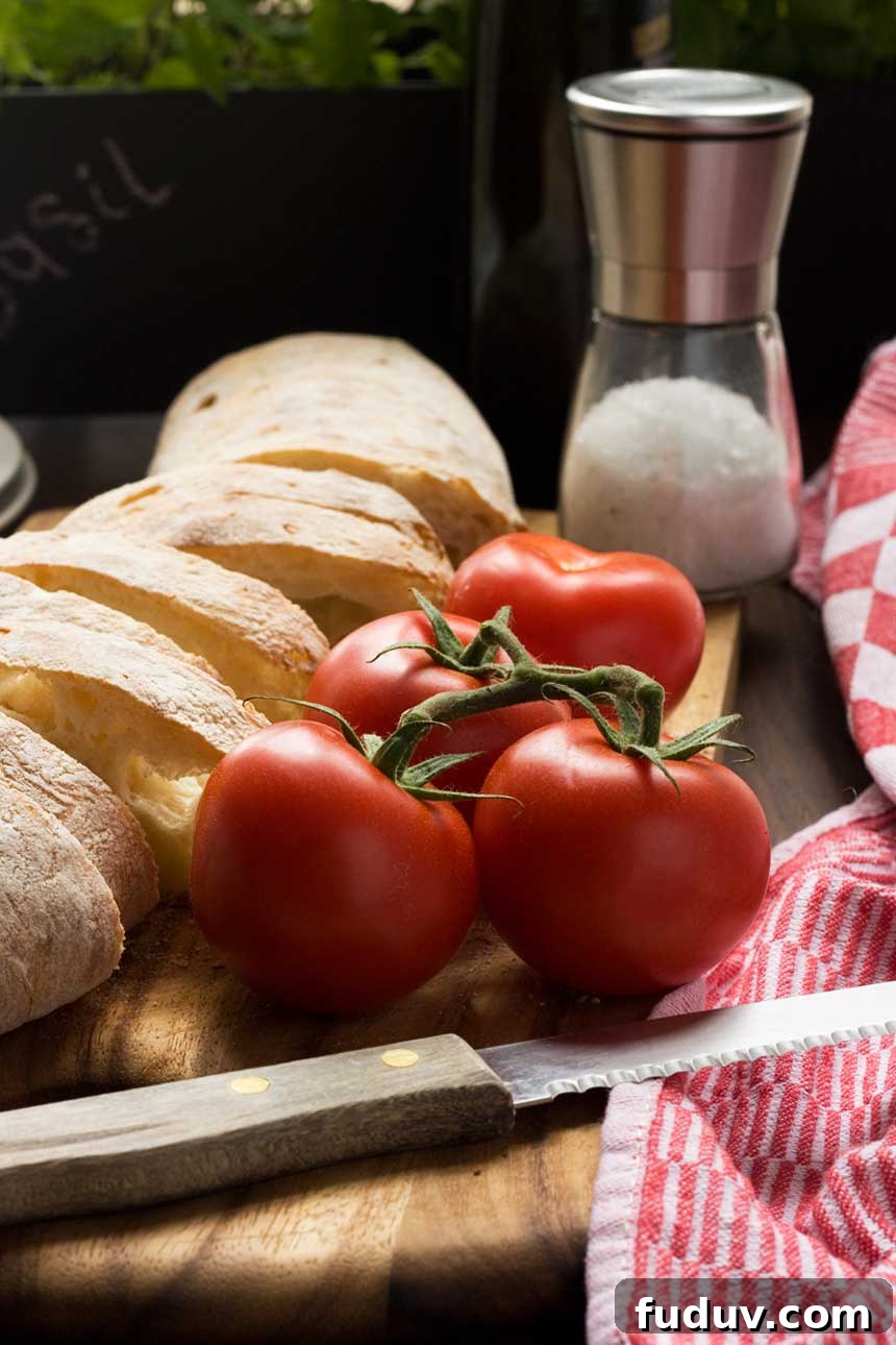 Pan con Tomate: Classic Spanish Tomato Toast Recipe 4 A close up of ingredients for pan con tomate on a wooden table