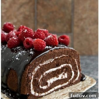 Easy Homemade Chocolate Cake Roll with Chocolate Ganache and Raspberries on Brown Tray