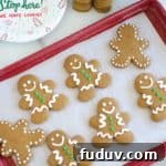 Classic Gingerbread Men Recipe for Perfect Holiday Cookies 8 gingerbread cookies on a red baking sheet