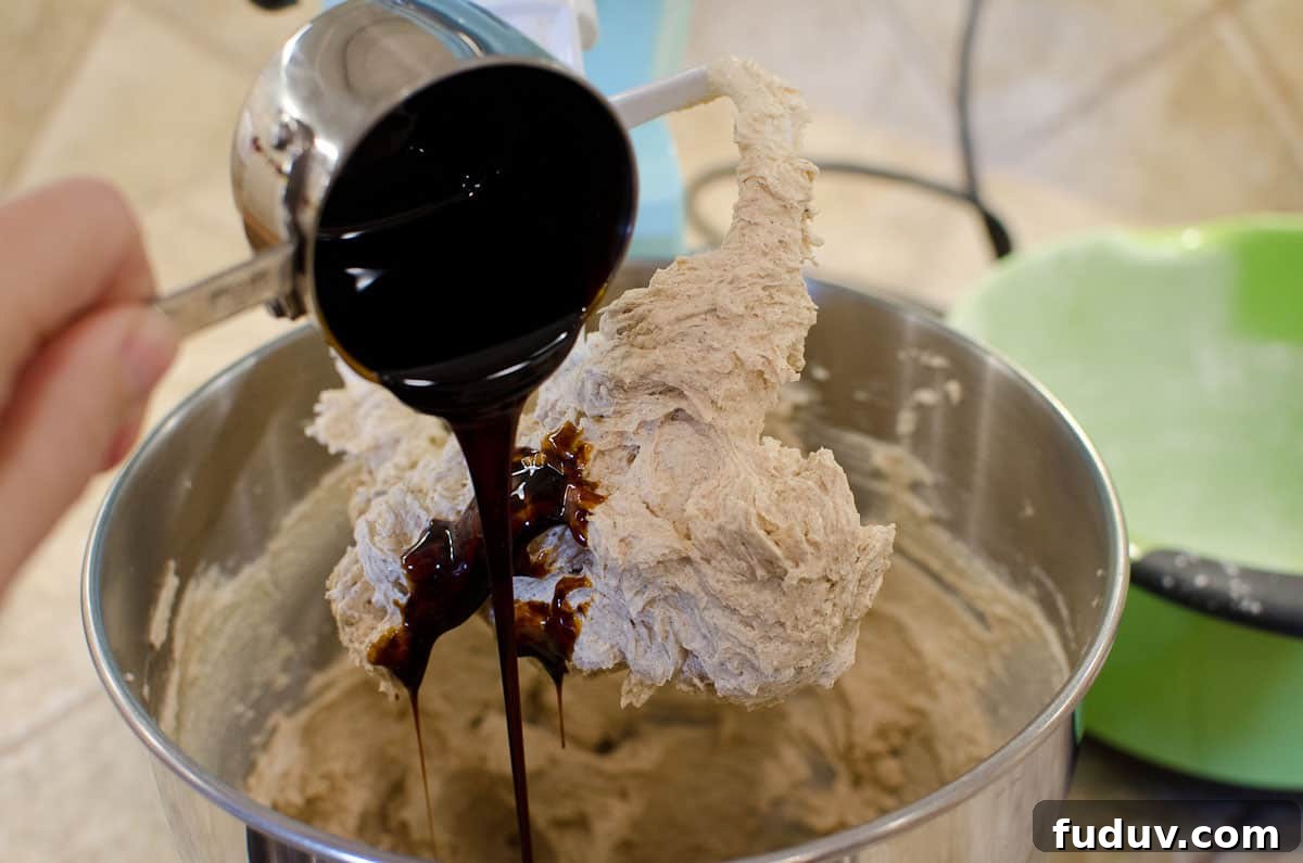 Classic Gingerbread Men Recipe for Perfect Holiday Cookies 3 pouring molasses into gingerbread cookie dough