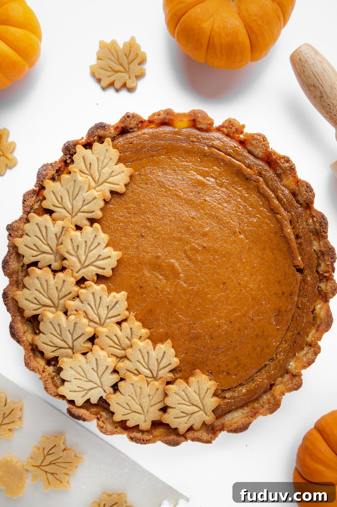 Sugar-Free Pumpkin Pie Recipe for Fall Holidays 2 Top down view of a sugar free pumpkin pie, with maple leaf-shaped sugar cookies decorating one side.