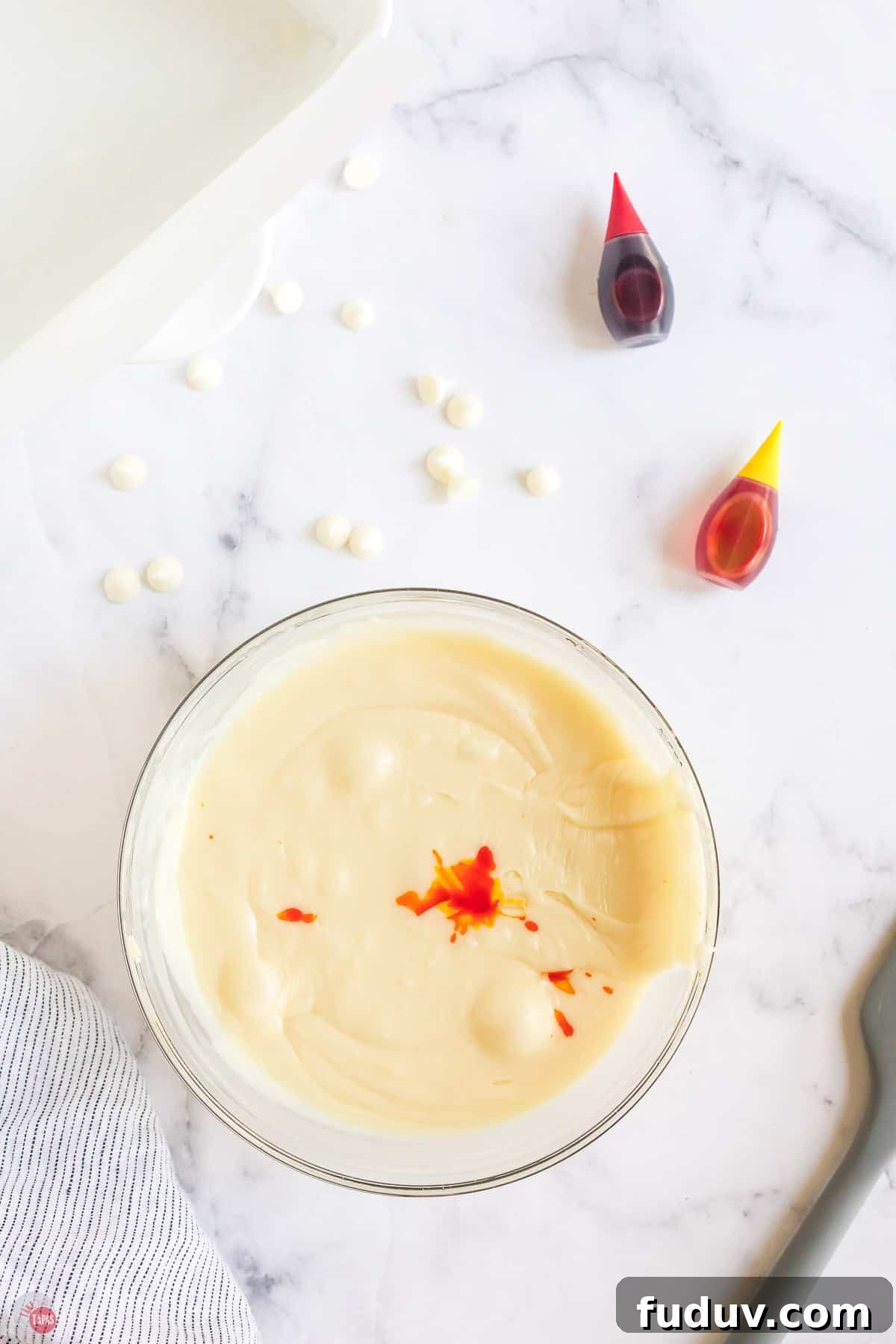 Candy Corn Fudge Recipe: Creamy Halloween Candy Treat 5 bowl of melted chocolate with food coloring in it