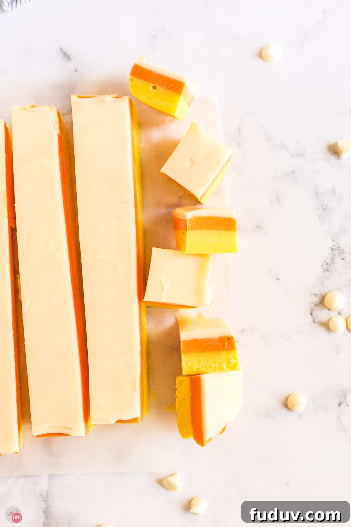 Candy Corn Fudge Recipe: Creamy Halloween Candy Treat 10 fudge cut into strips on a marble surface